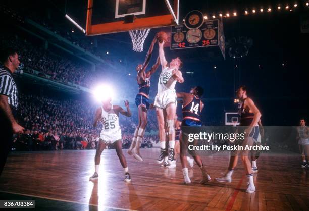 Wilt Chamberlain of the Philadelphia Warriors fights for the rebound with Tom Heinsohn of the Boston Celtics during an NBA game on November 25, 1959...