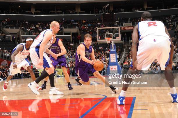 Beno Udrih of the Sacramento Kings drives against Chris Kaman of the Los Angeles Clippers at Staples Center on November 12, 2008 in Los Angeles,...