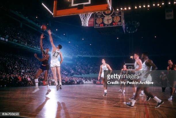 Wilt Chamberlain Philadelphia Warriors shoots a hook shot as Gene Conley of the Boston Celtics defends during an NBA game on November 25, 1959 at the...