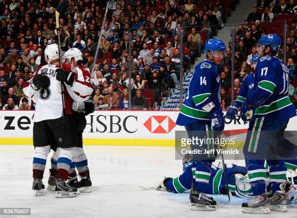 Wojtek Wolski of the Colorado Avalanche is congratulated by his teammates after scoring against Roberto Luongo of the Vancouver Canucks ending a...