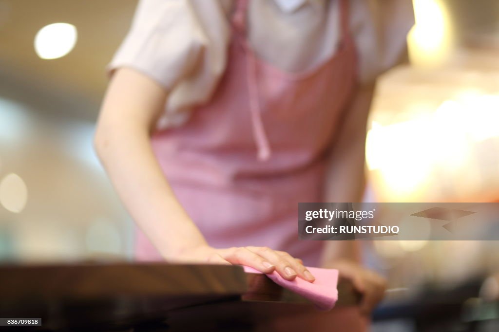 Waitress clearing table