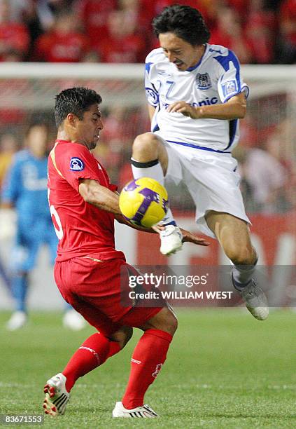 Gamba Osaka defenders Hashimoto Hideo steals the ball from Adelaide United's Jose Cassio in the second leg of the AFC Champions League final, being...