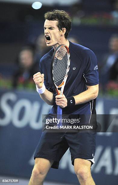 Andy Murray of Britain celebrates after winning a point against Gilles Simon of France in their men's singles match on the fourth day of the ATP...