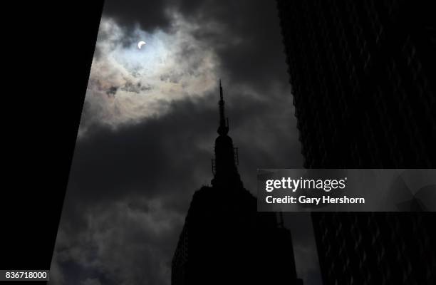 The sun is eclipsed by the moon over top of the Empire State Building in New York City on August 21, 2017.