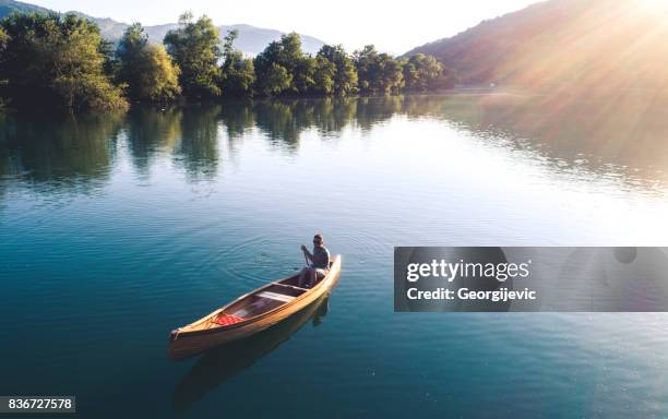 perfect combination of nature and sport - paddling boat stock pictures, royalty-free photos & images
