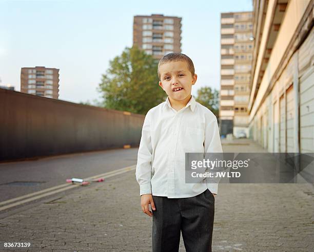 boy on housing estate, portrait - apartamento municipal imagens e fotografias de stock