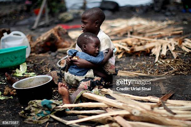 Congolese boy holds his brother at the Kibati displaced camp, November 13, 2008 on the outskirts of the town of Goma, Congo. The head of UN...