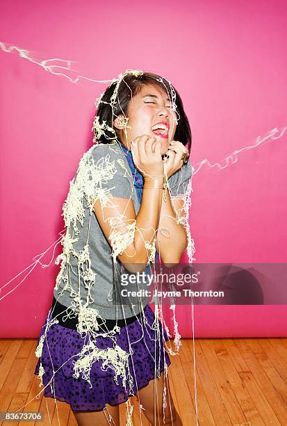hipster woman sprayed with spray string - party string stock pictures, royalty-free photos & images