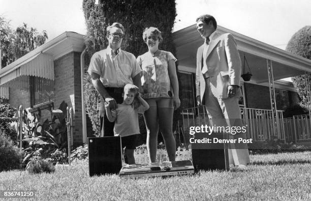 Gene Reeder, right, of Western Federal Savings, Presents Prize to Gent Family Kathryn and Gregory join their father, Terry, on prize-winning lawn, to...