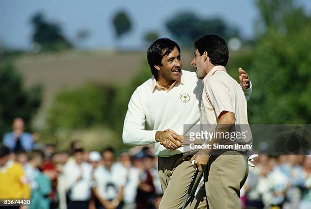 Spanish golfers Severiano Ballesteros and Jose Maria Olazabal shaking hands during a Ryder Cup match at The Belfry, Warwickshire, 24th September...
