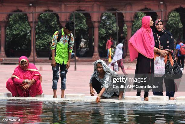 Indian Muslim women perform ablution at the Jama Masjid mosque in New Delhi on August 22, 2017. India's top court on August 22 banned a controversial...