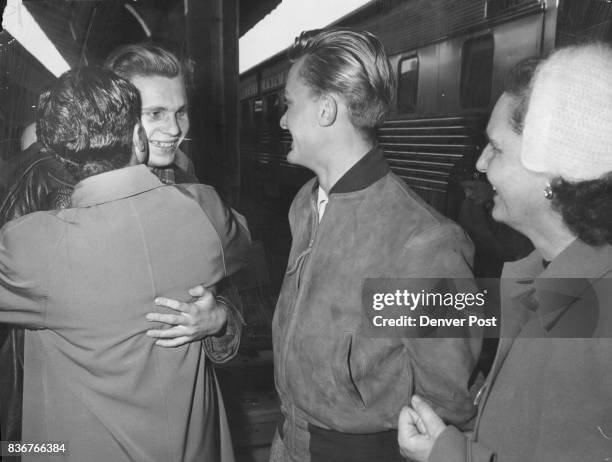 Istavan Johannes who fought in the streets of Tata, Hungary, is embraced by his uncle Julius Toth , 4575 Julian St., and his cousin Gustav Kalmar who...