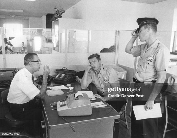 Denver Banking Firm Robbed William Barnett, left, manager of the Lee man Industrial Bank, 25 East Fifth Ave., tells two policemen of holdup staged at...