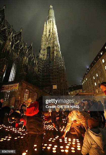 People light thousands of candles to form the words "Ein Funke Wärme" to point out growing poverty in Austria, on November 14, 2008 in the centre of...