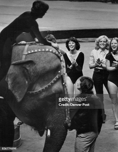 Lynda hatfield, Center, and others Applaud a Lesson head circus showgirl Sue-Sue Sparkman shows how to ride an elephant Credit: Denver Post