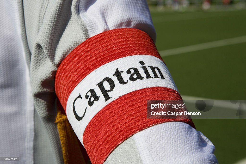 A person wearing a 'captain' arm band