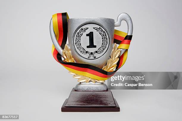 first place trophy cup wrapped in a sash with the german flag colors - fusciacca foto e immagini stock
