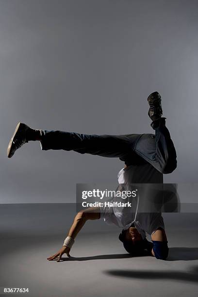 a b-boy doing a headspin freeze breakdance move - headspin stock pictures, royalty-free photos & images