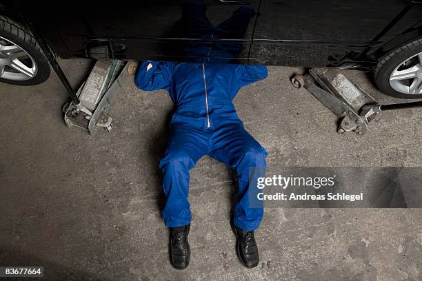 a car mechanic servicing a car - 自動車整備工 ストックフォトと画像