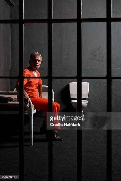 prisoner sitting on a bed in a prison cell - 1 2 finale stock pictures, royalty-free photos & images