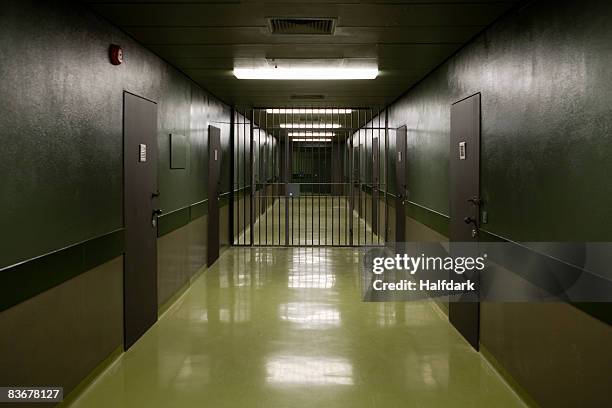an empty prison corridor - prison door stock pictures, royalty-free photos & images