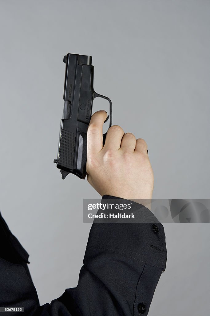 A hand holding a gun