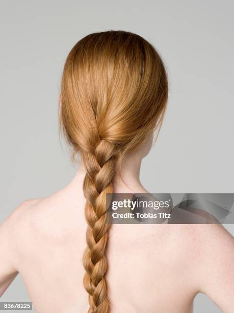 a young naked woman with a braided ponytail, rear view - braiding plaits stock pictures, royalty-free photos & images