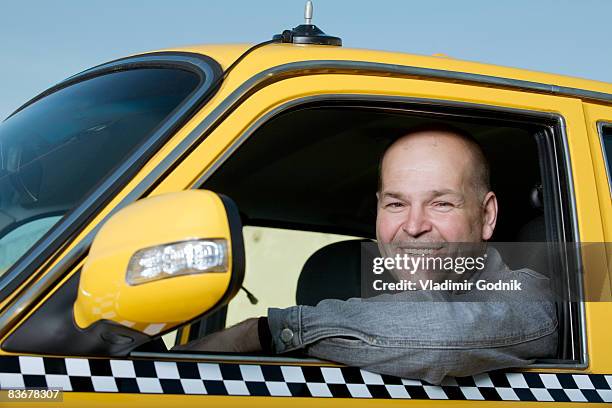 a taxi driver sitting in his car and smiling - taxi driver stock pictures, royalty-free photos & images