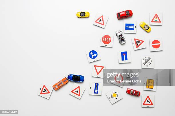 a white wall with miniature road signs & toy cars - toy cars photos et images de collection