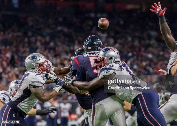 Houston Texans quarterback Brandon Weeden gets sacked by New England Patriots defensive lineman Adam Butler during the NFL preseason game between the...