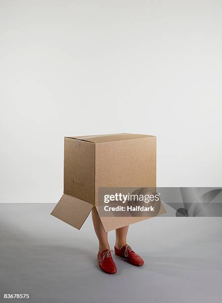 a person standing inside a box - shoes box stock-fotos und bilder