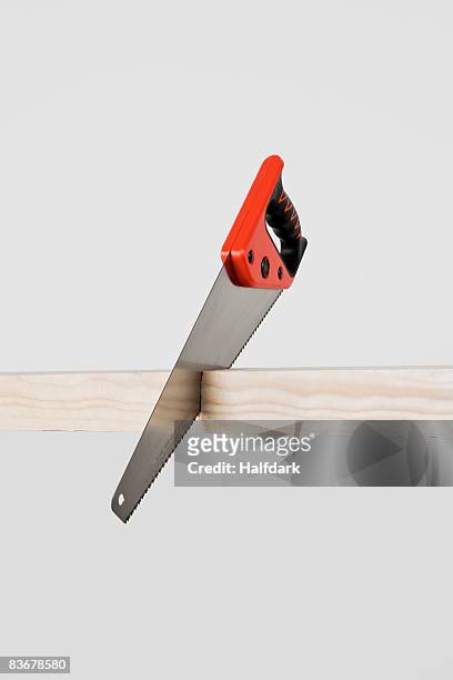 a saw cutting a plank of wood - sawing stock-fotos und bilder