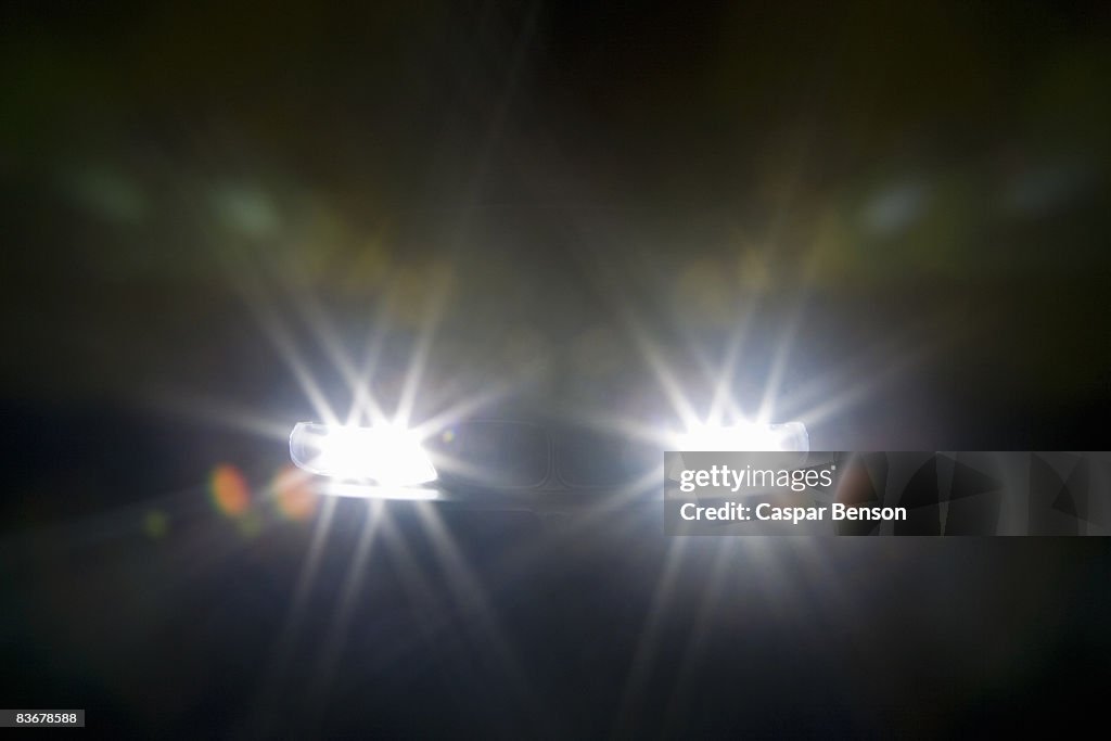 A car headlights illuminated at night