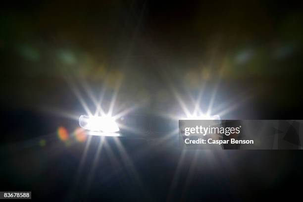 a car headlights illuminated at night - car light bildbanksfoton och bilder