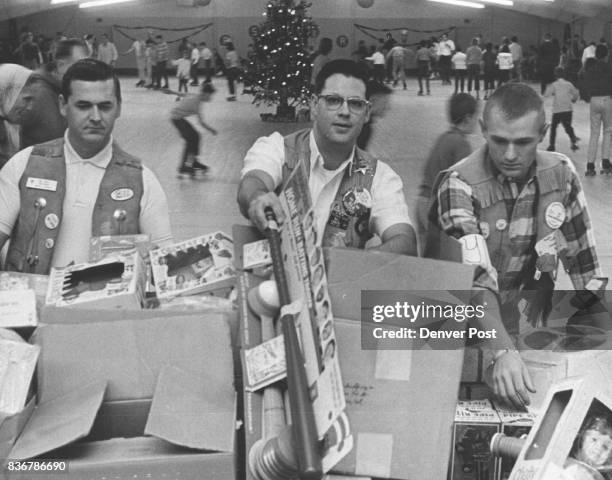 William La Bate, left, president of the Southwest Adams County Jaycees, and Kenneth Deem, project chairman, prepare gifts for 1,000 special education...