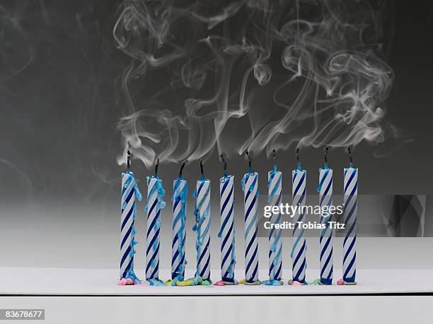 a row of extinguished blue birthday candles - birthday candles stock pictures, royalty-free photos & images