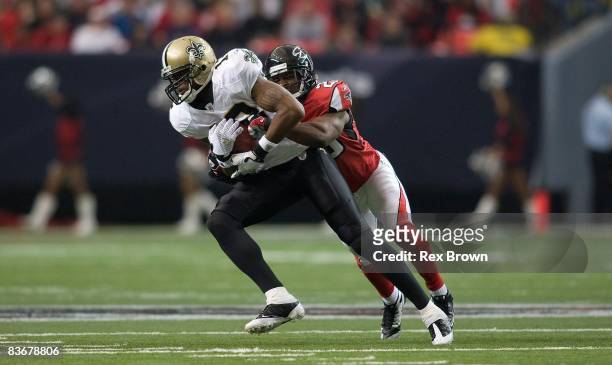 Brent Grimes of the Atlanta Falcons brings down Marques Colston of the New Orleans Saints at Georgia Dome on November 9, 2008 in Atlanta, Georgia....