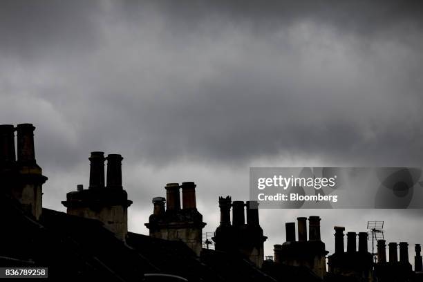 Chimneys are silhouetted on row of terraced houses on a suburban street in Bath, U.K. On Monday, Aug. 21, 2017. U.K. Property prices stagnated in...