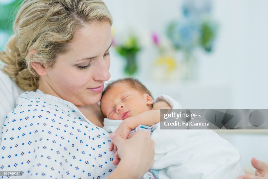 Holding Her Newborn's Hand