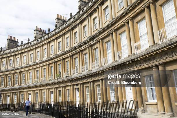 Pedestrian passes a row of terraced houses on a suburban street in Bath, U.K. On Monday, Aug. 21, 2017. U.K. Property prices stagnated in July as a...