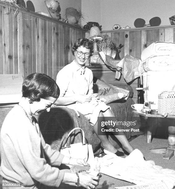 Mrs. Charles Yeoman studies a pattern to match the stocking bunny's head to his body with approval by Mrs. Jack Anderson, feathering seams on a...