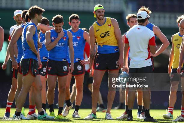 Sam Naismith shares a laugh with a team mate as they listen to instructions during a Sydney Swans AFL training session at Sydney Cricket Ground on...