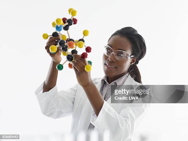 laboratory technician studying molecular model - science curiosity stock pictures, royalty-free photos & images