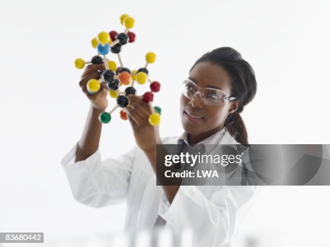 Laboratory technician studying molecular model Laboratory technician studying molecular model