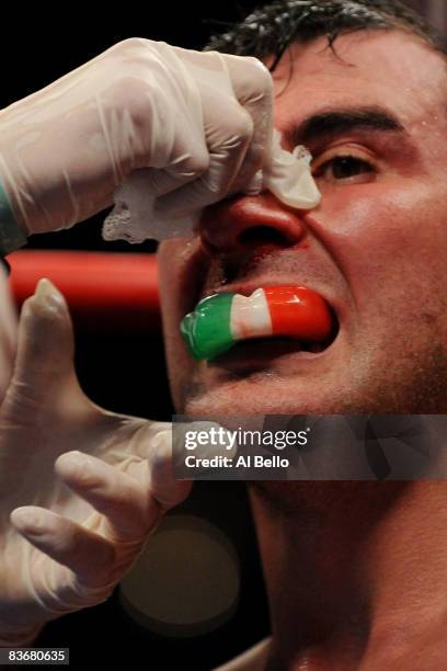Joe Calzaghe of Wales is tended to during the Ring Magazine Light Heavyweight Championship bout against Roy Jones Jr at Madison Square Garden...