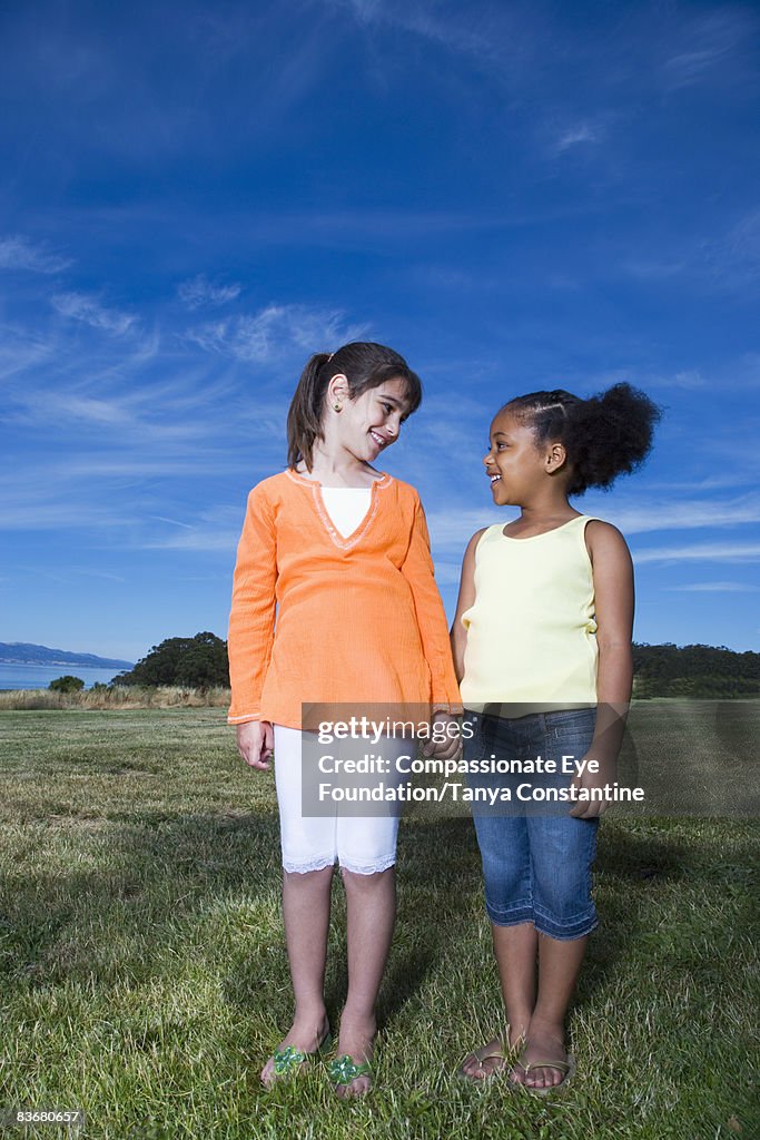 Two little girls holding hands