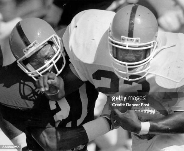 Steve Atwater and Sammy Winder bang heads during a short scrimmage at Broncos camp in Greeley. Credit: The Denver Post