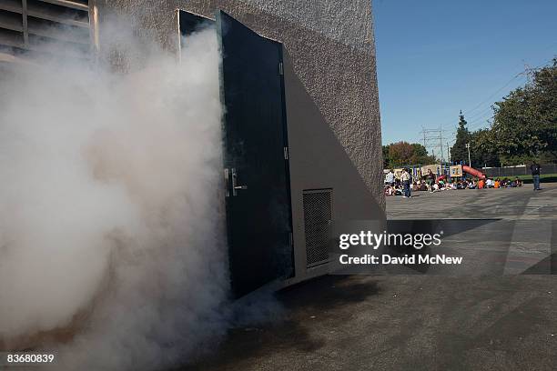 Smoke billows from a simulated burning school auditorium as students of Stevenson Elementary School are gatheed on the playground during the...