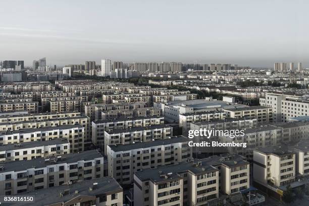 Residential buildings stand in Baotou, Inner Mongolia, China, on Friday, Aug. 11, 2017. China's economy showed further signs of entering a...