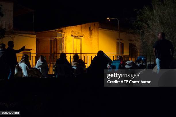 People gather and wait in a street, early morning in Ischia, on August 22 after an earthquake hit the popular Italian tourist island off the coast of...